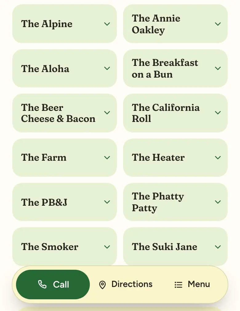 The burger restaurant concept’s menu on a phone: the specialty burgers as two-up green tiles with serif names, above a floating pill with Call, Directions and Menu